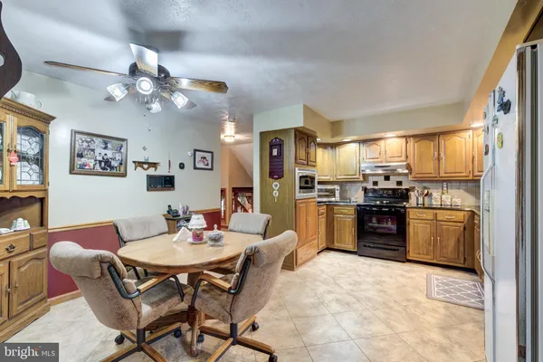 a view of a dining room with furniture and a kitchen