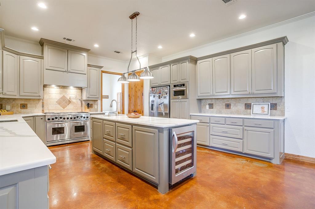 2608 Turkey Creek Road Mineral Wells, TX 76067 - Photo 11 of 39 a kitchen with stainless steel appliances a stove a sink and a refrigerator