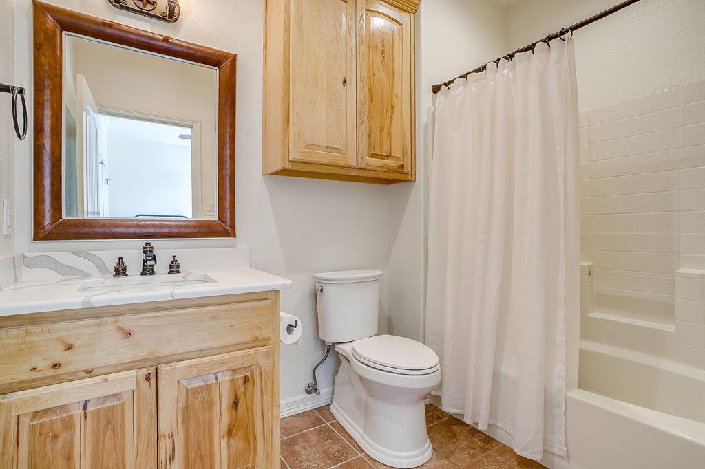 2608 Turkey Creek Road Mineral Wells, TX 76067 - Photo 23 of 39 a bathroom with a toilet a sink and a mirror