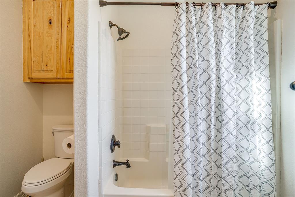 2608 Turkey Creek Road Mineral Wells, TX 76067 - Photo 26 of 39 a bathroom with a shower curtain