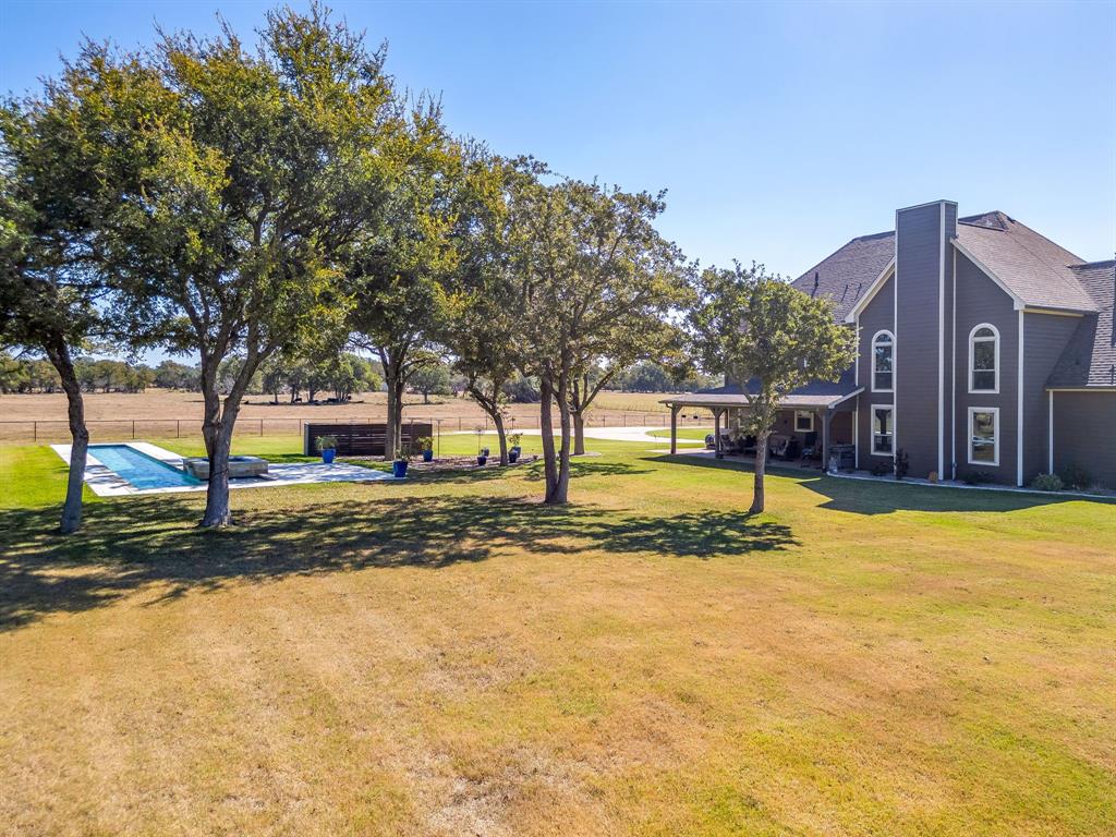 2608 Turkey Creek Road Mineral Wells, TX 76067 - Photo 31 of 39 a view of a yard with a tree