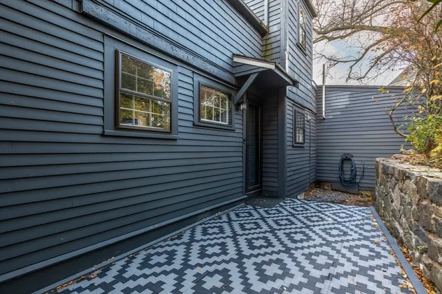 a view of a house with a door and wooden walls