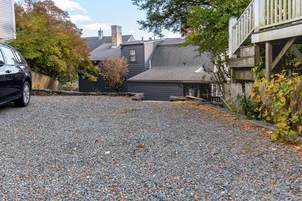 a view of a house with a yard and sitting area