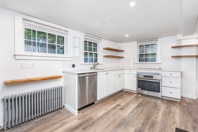 a kitchen with a stove oven and sink
