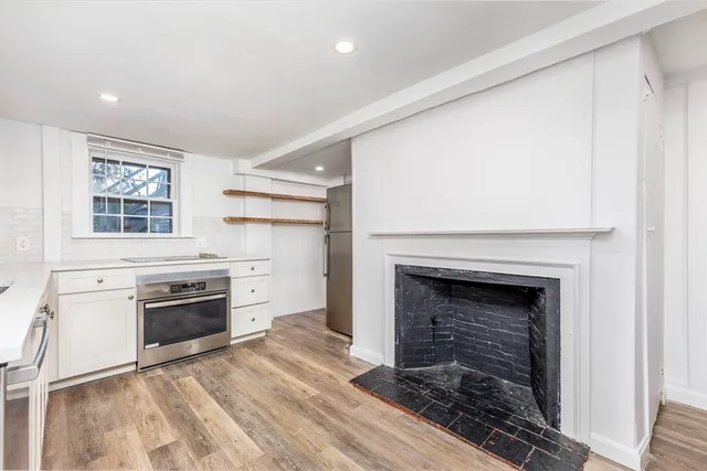 a view of a kitchen with a stove cabinets and wooden floor