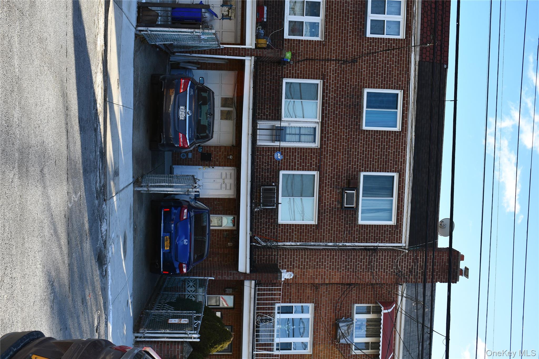 158-04 84th Road Queens, NY 11432 - Photo 2 of 17 a car parked in front of a building