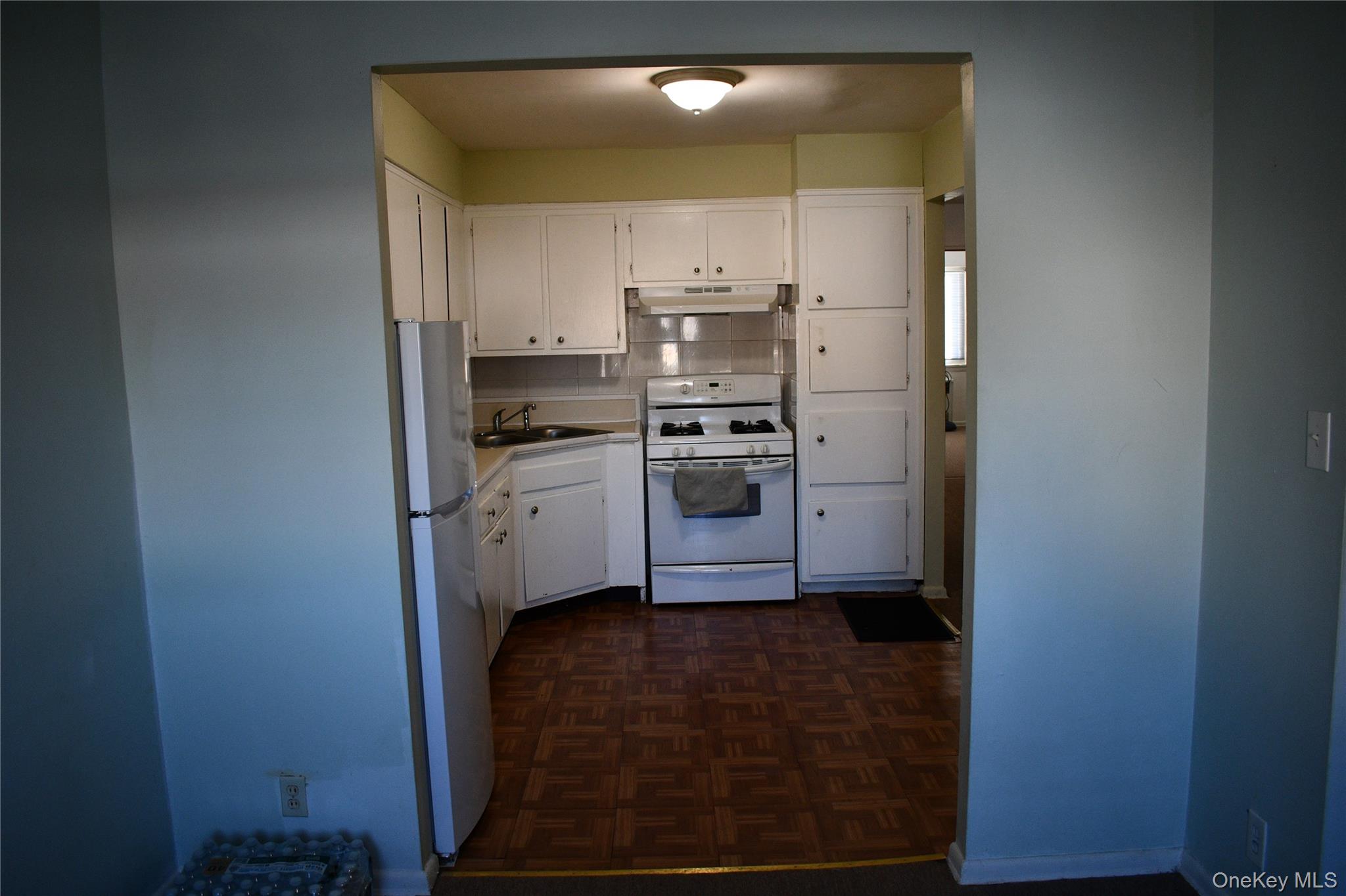 158-04 84th Road Queens, NY 11432 - Photo 3 of 17 a kitchen with a sink stainless steel appliances and cabinets