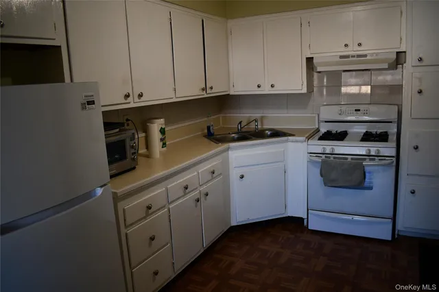 a kitchen with cabinets appliances and a sink