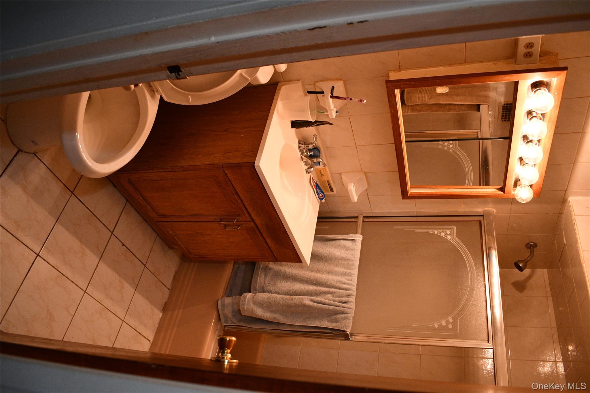 158-04 84th Road Queens, NY 11432 - Photo 6 of 17 a bathroom with a sink a toilet and mirror