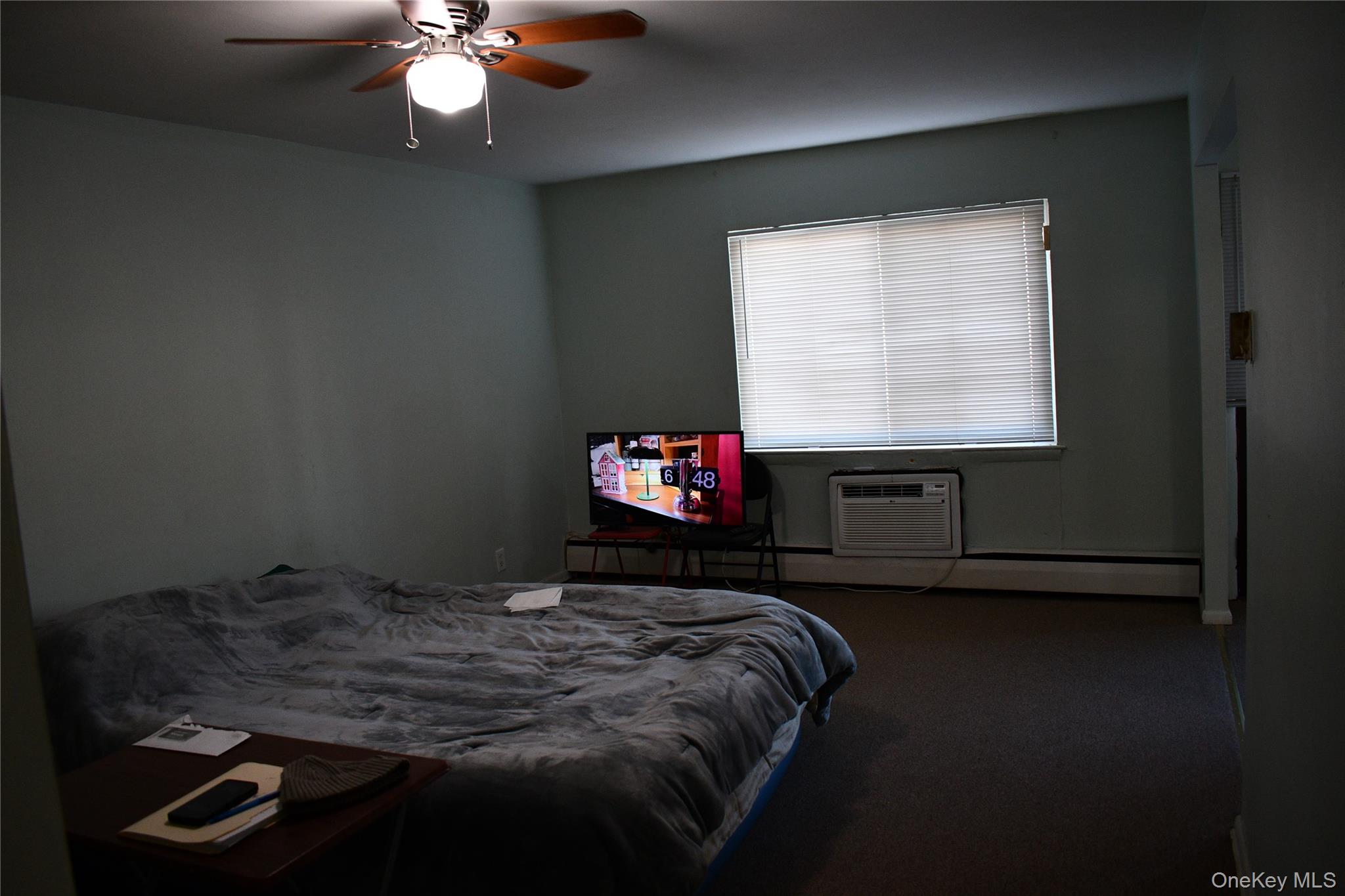 158-04 84th Road Queens, NY 11432 - Photo 8 of 17 a bedroom with a bed and a chandelier