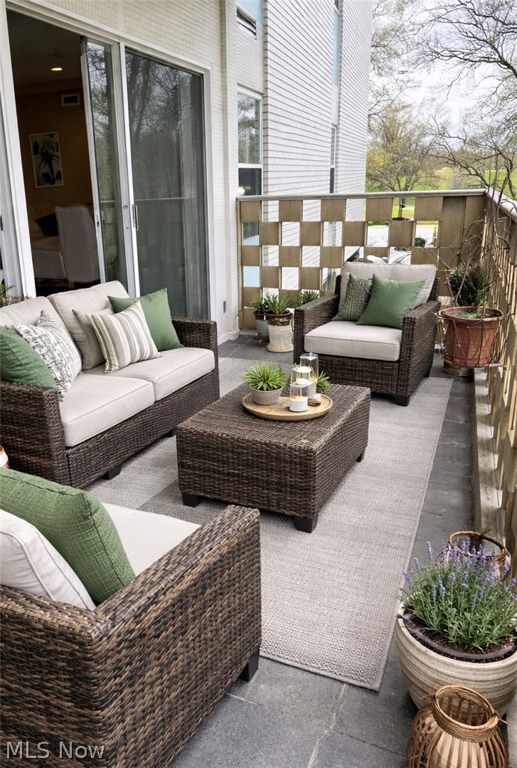 275 North Portage Path, Unit 3B Akron, OH 44303 - Photo 14 of 16 Expansive outdoor patio featuring durable flooring, a decorative privacy screen, and direct access to interior living spaces via sliding glass doors