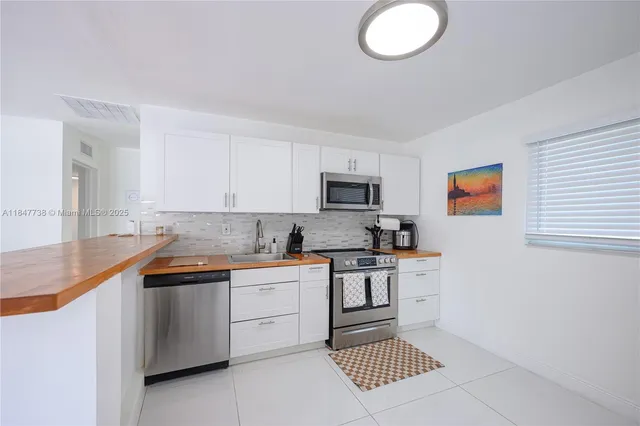 a kitchen with stainless steel appliances granite countertop a sink and cabinets