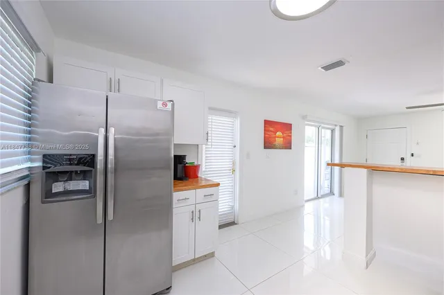 a kitchen with stainless steel appliances a refrigerator and a stove