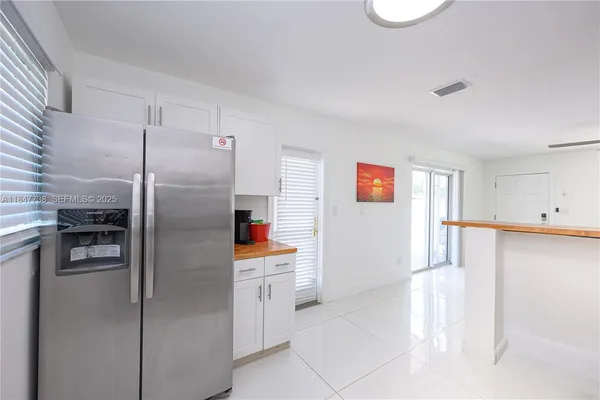 a kitchen with stainless steel appliances a refrigerator and a stove