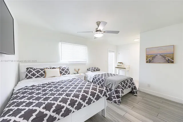 a bedroom with double bed and a chandelier