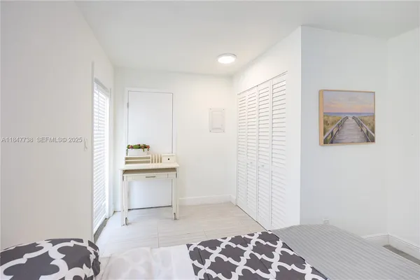 a room with a bed and a view of bathroom