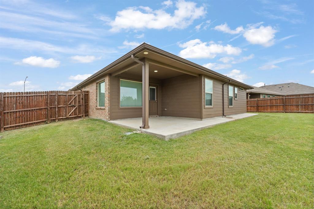4600 Fringetree Way Crowley, TX 76036 - Photo 29 of 40 Expansive backyard featuring a covered patio, a manicured lawn, and a wood privacy fence