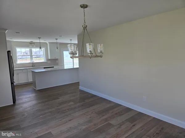 a view of a kitchen with wooden floor and a sink