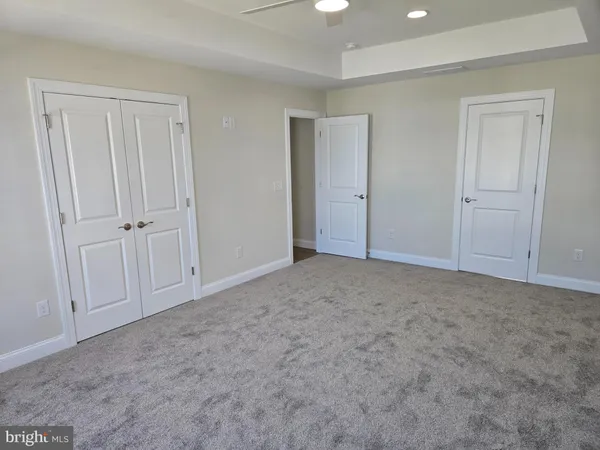 a view of an empty room and closet area
