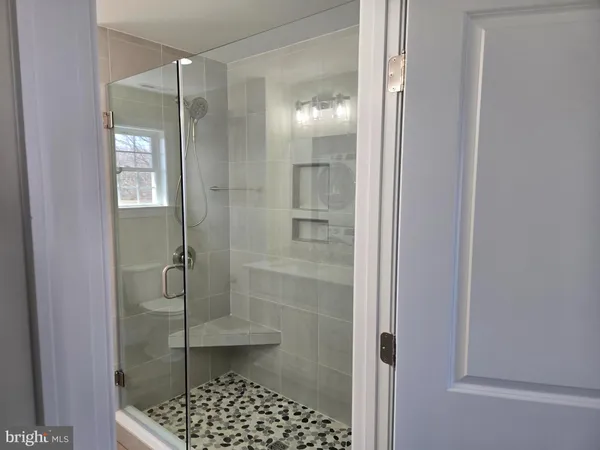 a bathroom with a glass shower door
