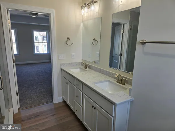 a bathroom with a double vanity sink and mirror