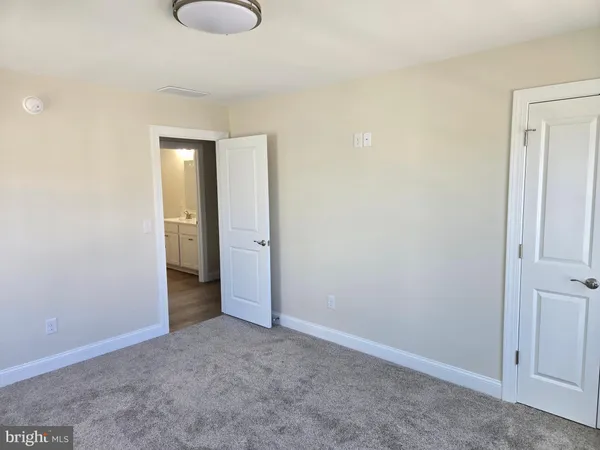 an empty room with closet area