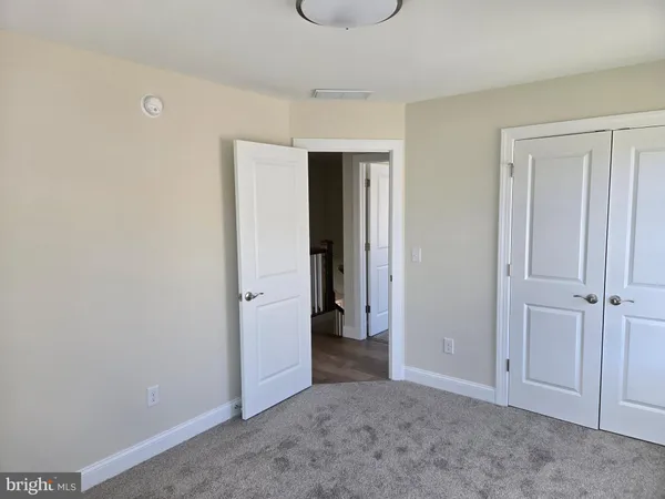 an empty room with closet area
