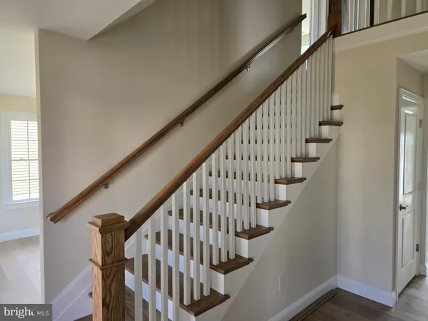 a view of entryway with wooden floor and stairs