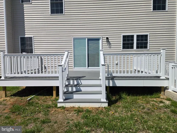 a view of a house with a yard and deck