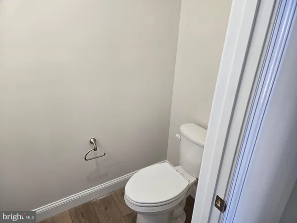 a white toilet sitting next to a shower