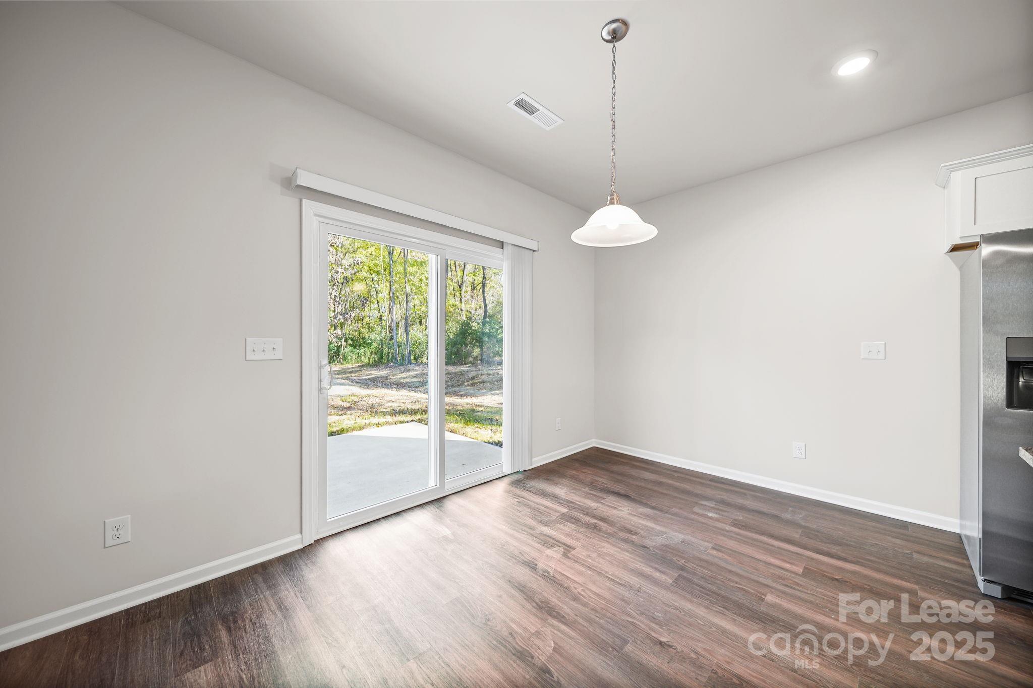 3200 Polk And White Road, Unit A Charlotte, NC 28269 - Photo 24 of 35 a view of an empty room with wooden floor and a window