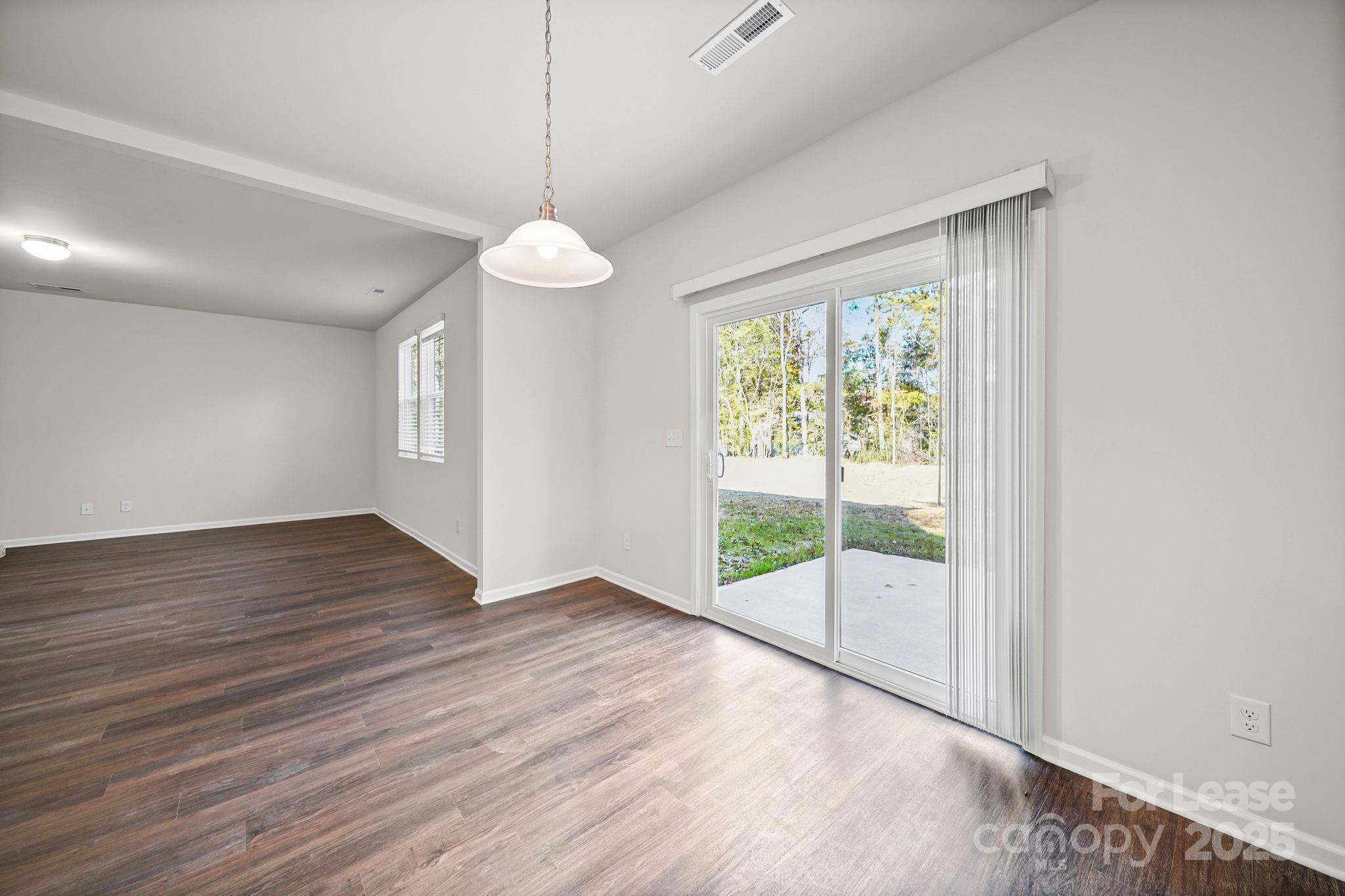 3200 Polk And White Road, Unit A Charlotte, NC 28269 - Photo 25 of 35 a view of an empty room with wooden floor and a window