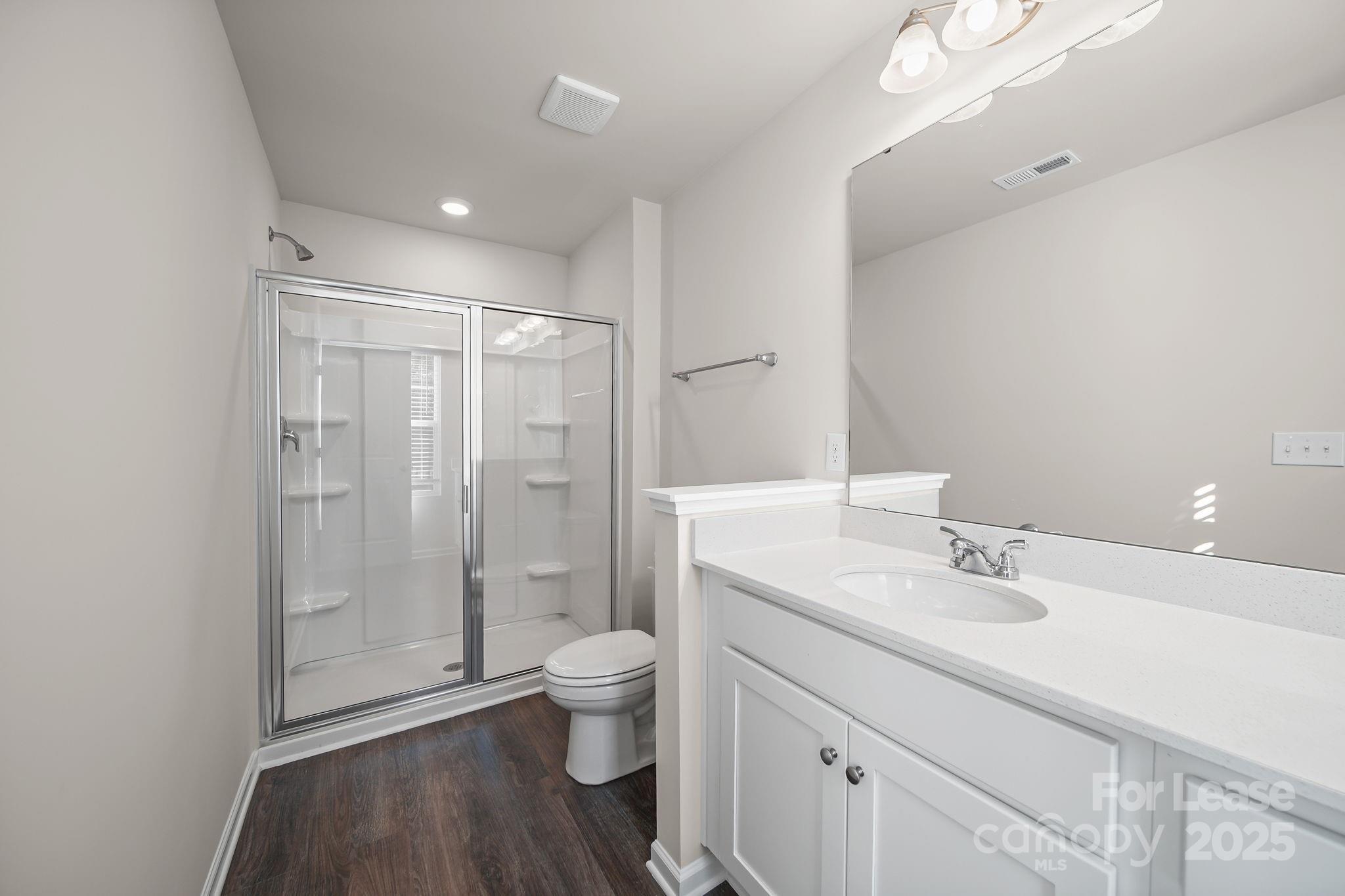 3200 Polk And White Road, Unit A Charlotte, NC 28269 - Photo 10 of 35 a bathroom with a granite countertop sink a toilet and shower