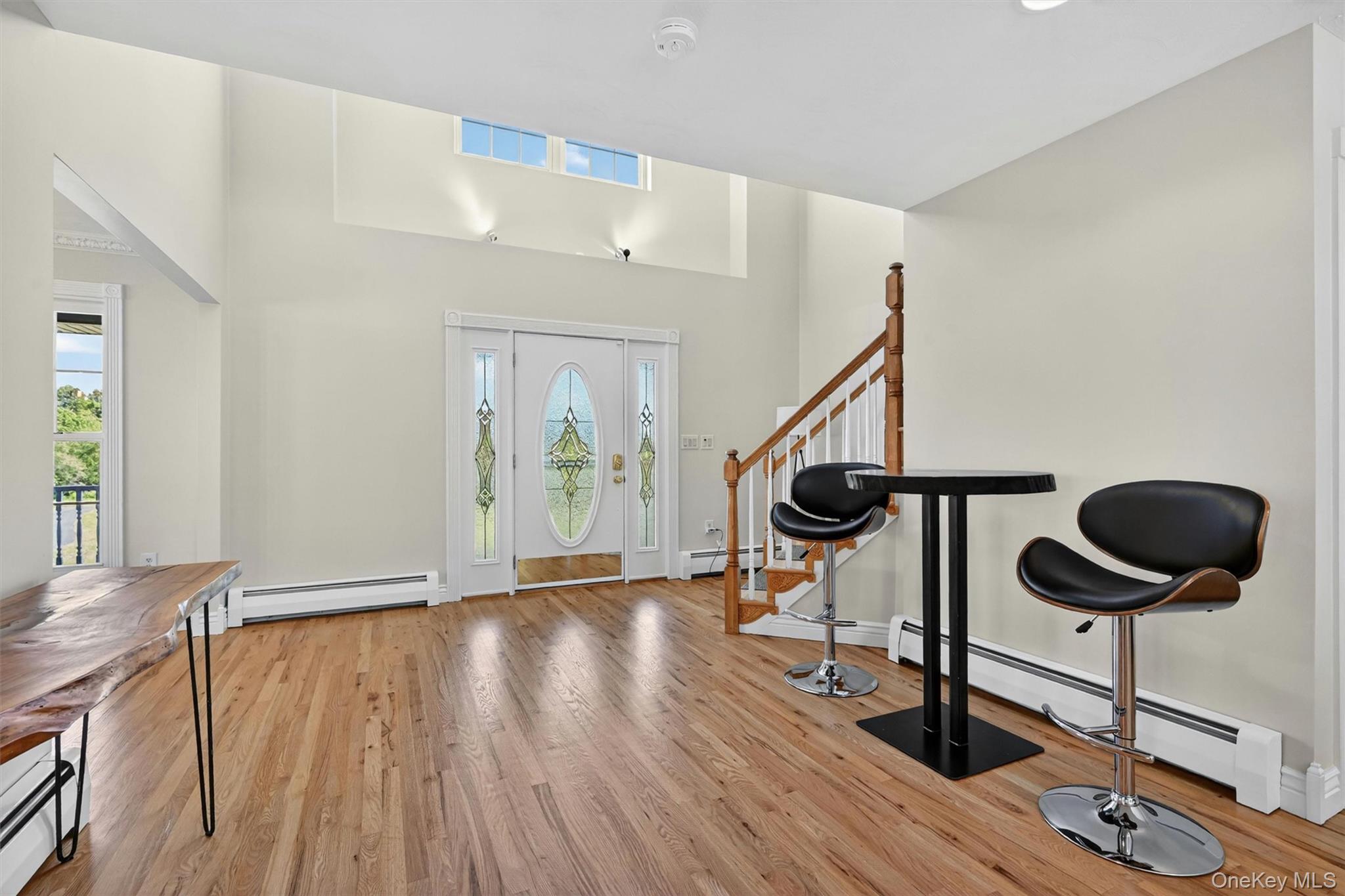 954 Ridgebury Road New Hampton, NY 10958 - Photo 9 of 45 The entry feels open and airy, with natural light, tall ceilings, and a graceful staircase setting the tone for the rest of the home.