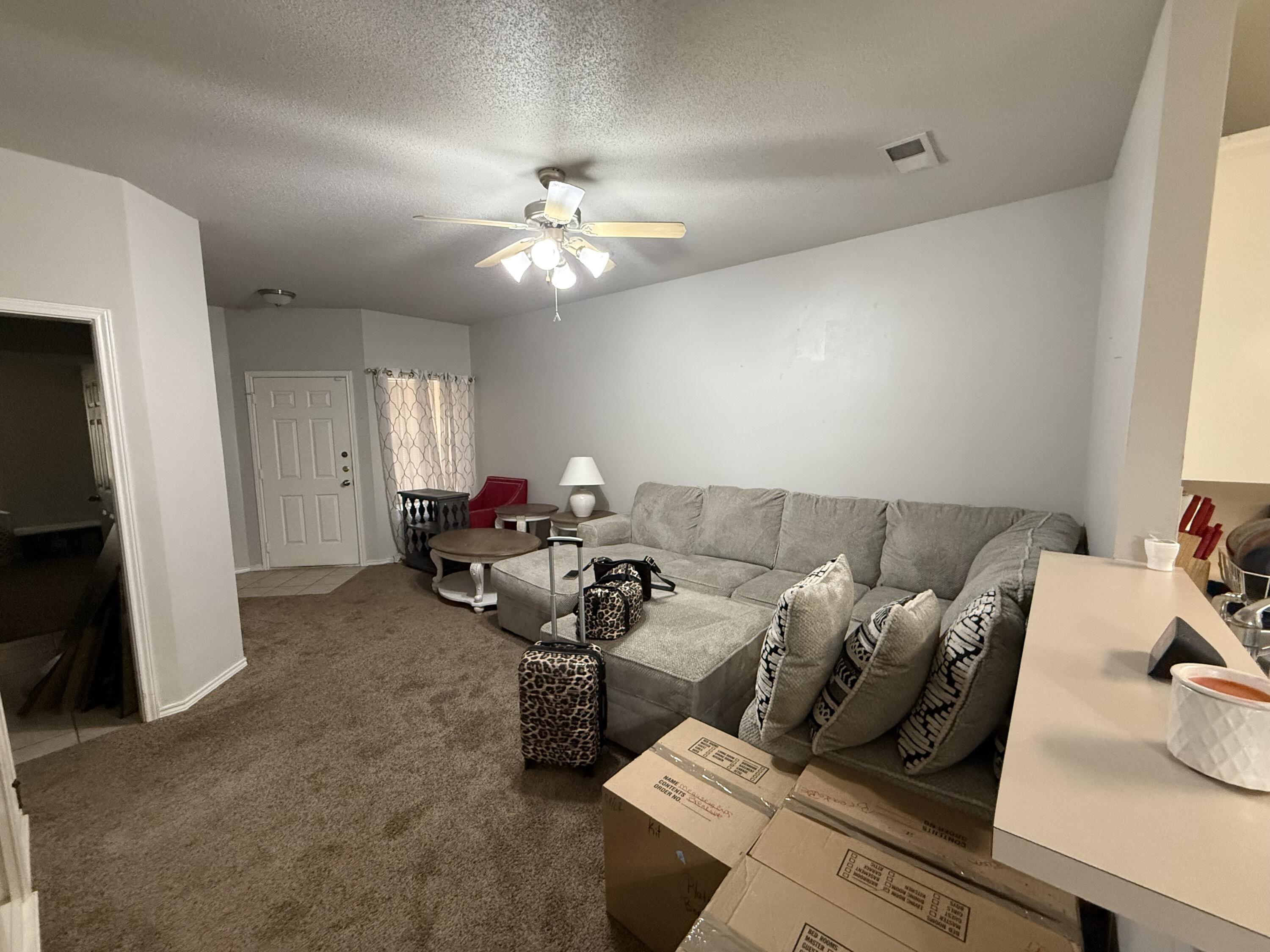507 North Clinton Avenue Lubbock, TX 79416 - Photo 2 of 10 a living room with furniture and a chandelier