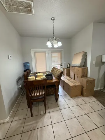 a living room with a couch and a chandelier