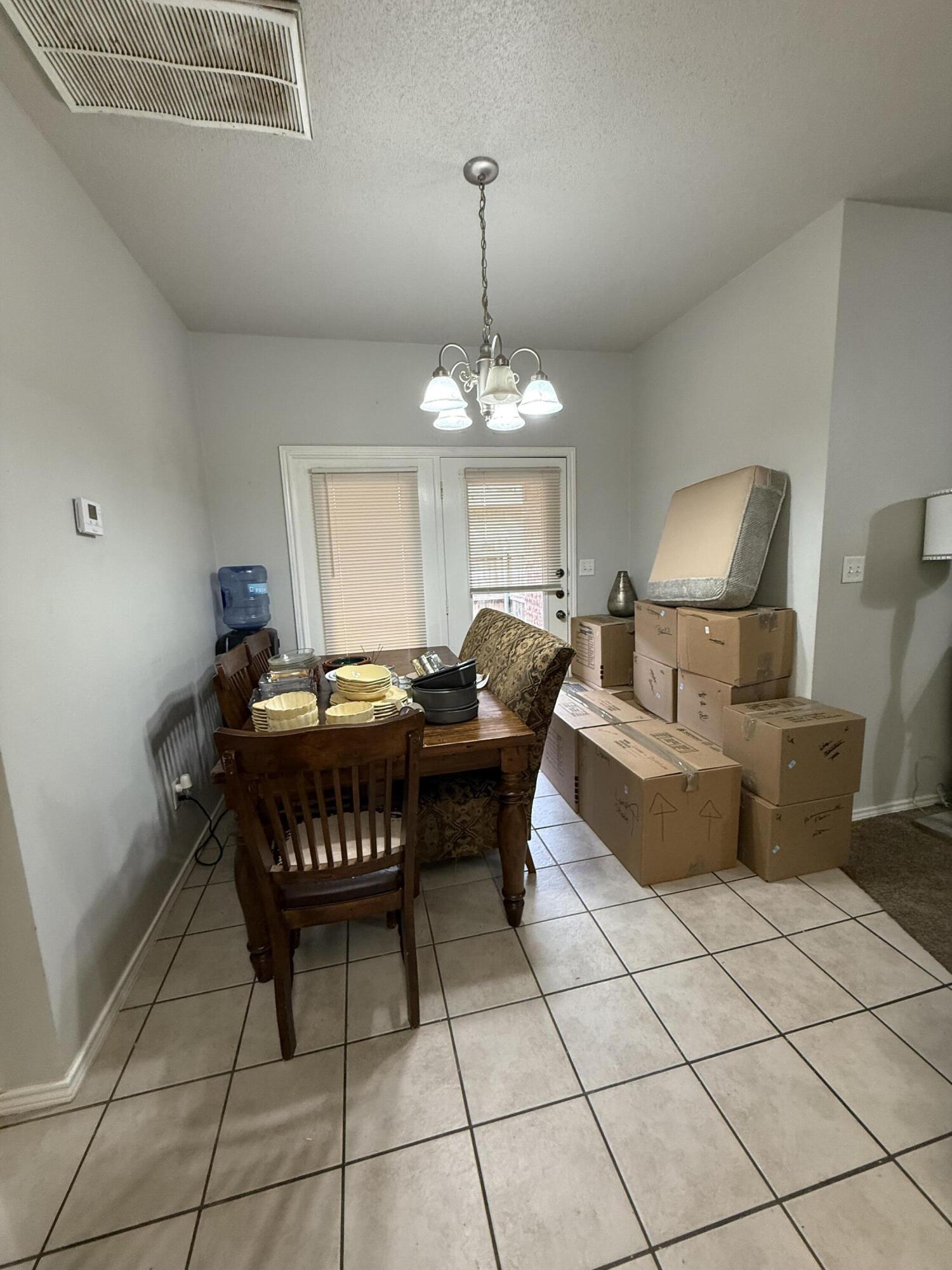 507 North Clinton Avenue Lubbock, TX 79416 - Photo 4 of 10 a living room with a couch and a chandelier