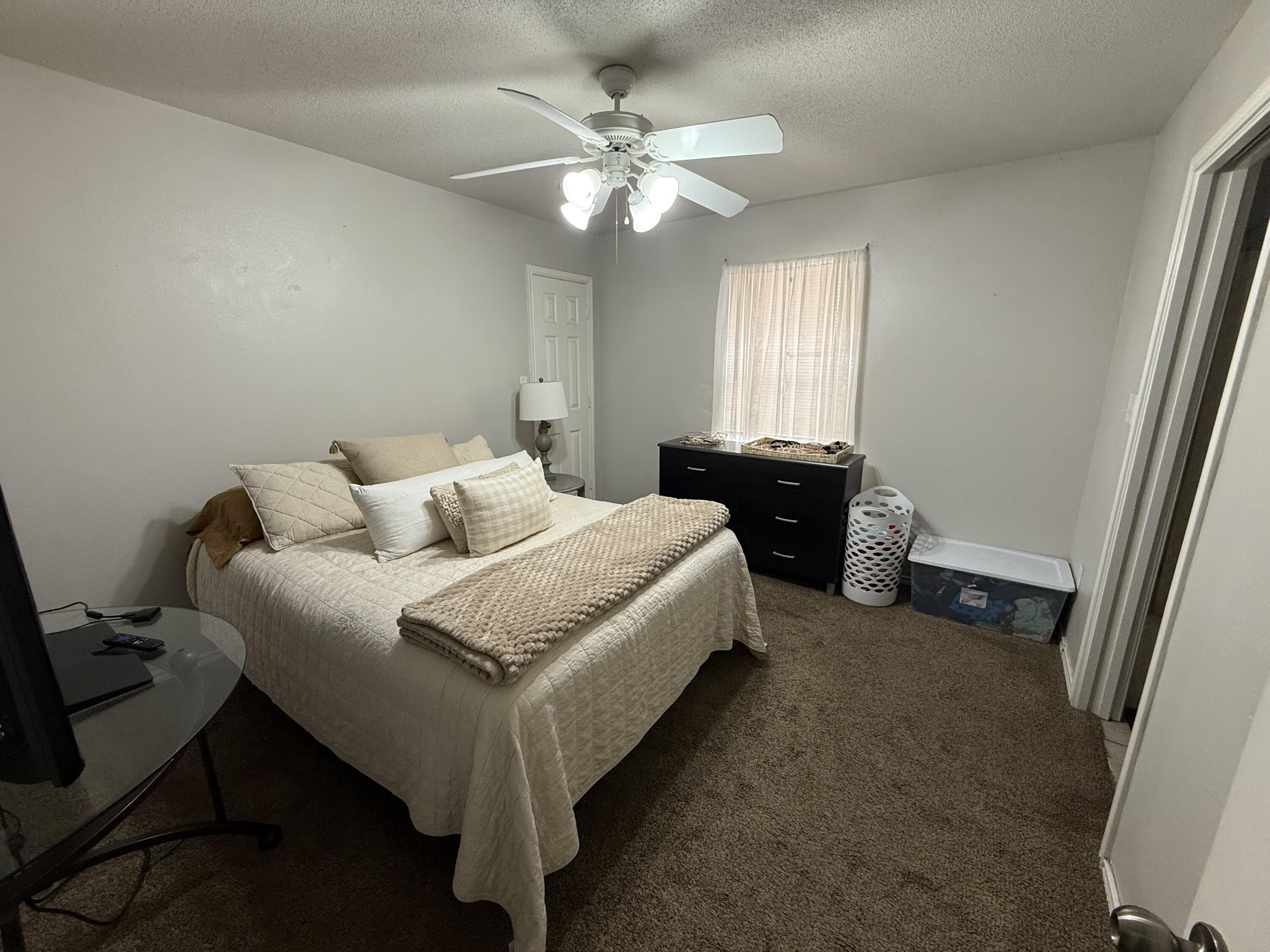 507 North Clinton Avenue Lubbock, TX 79416 - Photo 7 of 10 a spacious bedroom with a bed and window