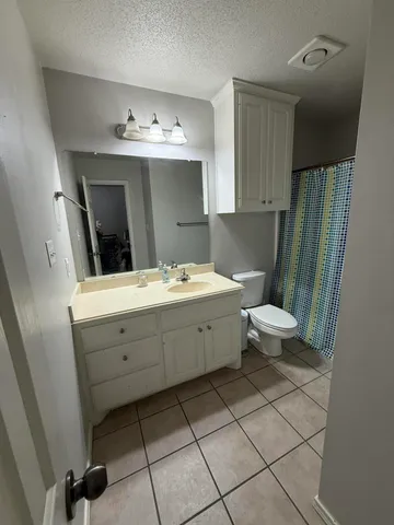 a bathroom with a sink toilet and mirror