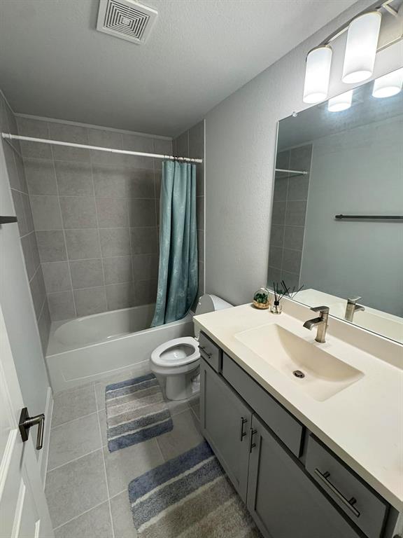 8628 Spindletop Drive Fort Worth, TX 76120 - Photo 18 of 21 a bathroom with a sink a toilet and shower