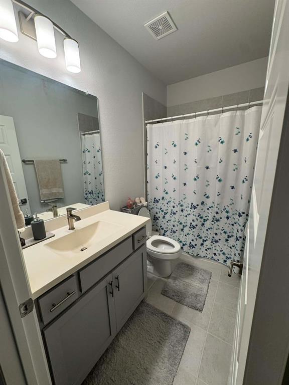 8628 Spindletop Drive Fort Worth, TX 76120 - Photo 19 of 21 a bathroom with a sink toilet and shower