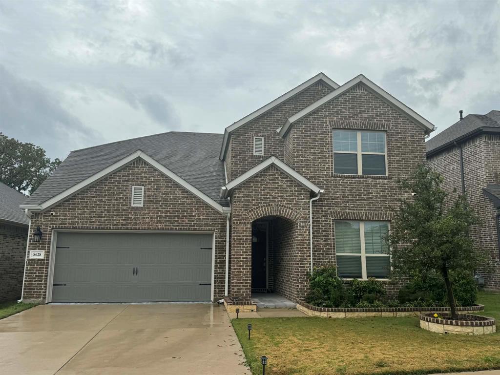 8628 Spindletop Drive Fort Worth, TX 76120 - Photo 2 of 21 a front view of a house with small garden