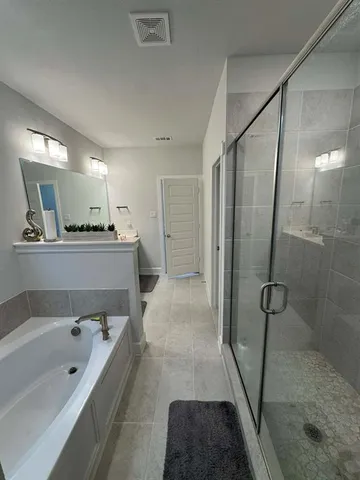 a bathroom with a bathtub and a shower