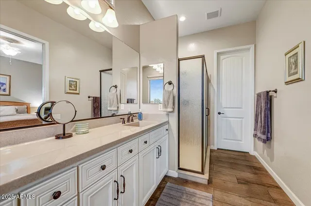 a bathroom with a bathtub a double vanity sink and a mirror