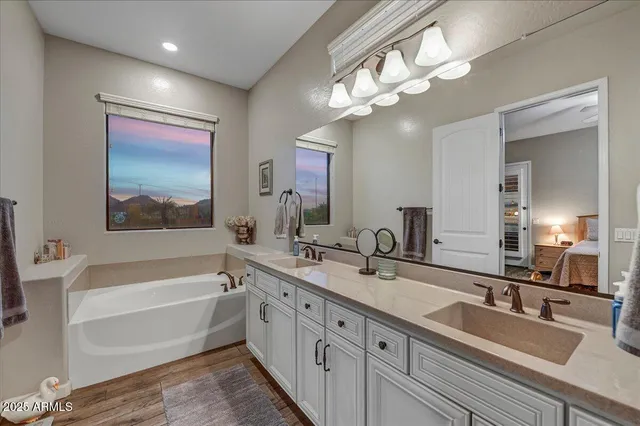 a spacious bedroom with a bed and a potted plant