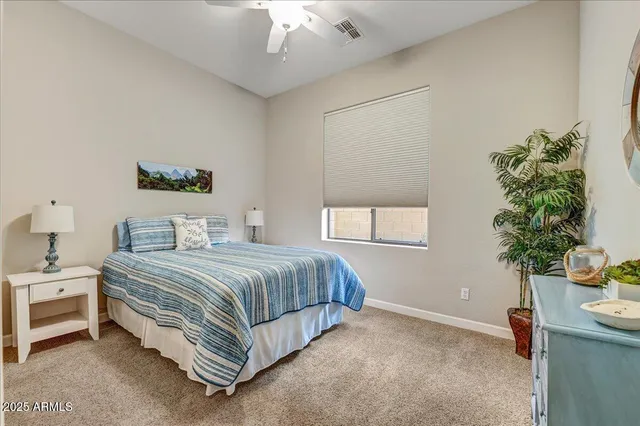 a bathroom with a sink a toilet a mirror and shower curtain
