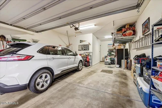 a view of a patio with couches table and chairs under an umbrella with a big yard