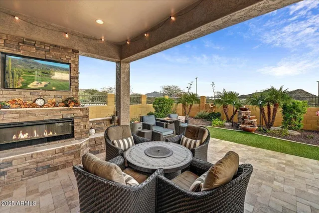 a view of a swimming pool with an outdoor seating and a yard
