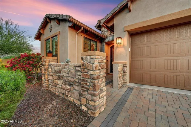 an aerial view of a house with a garden and mountain view