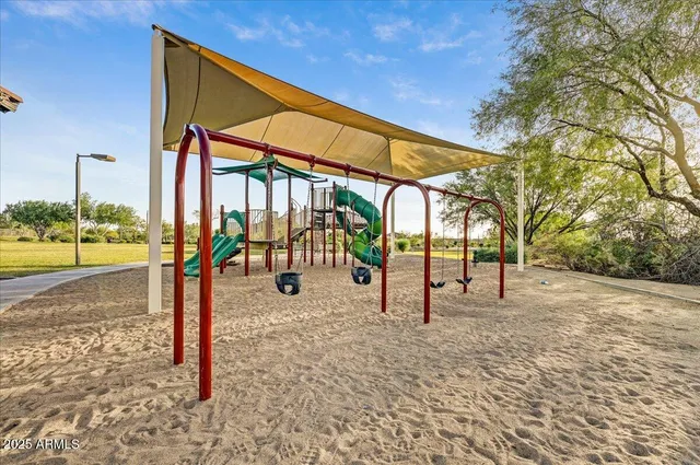 a living room with a floor to ceiling window and wooden floor